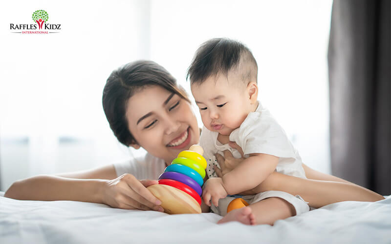 Toddler playing with his mum