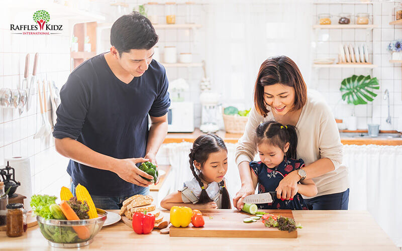 A family cooking and preparing healthy food together.