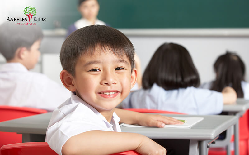 Happy preschool child smiling during emotional development activities.