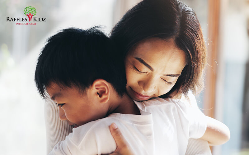 Mother and child hugging to support healthy emotional development.