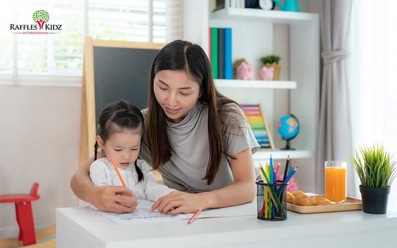 Raffles Kidz preschool teacher guiding children in hands-on inquiry-based learning activity